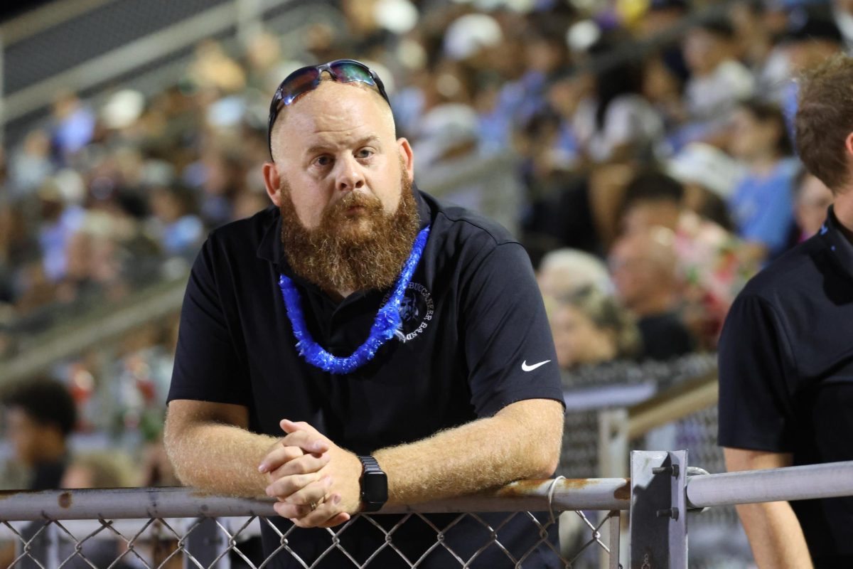 Director Nicholas Shurtleff observes the drumline as they perform for the student section.