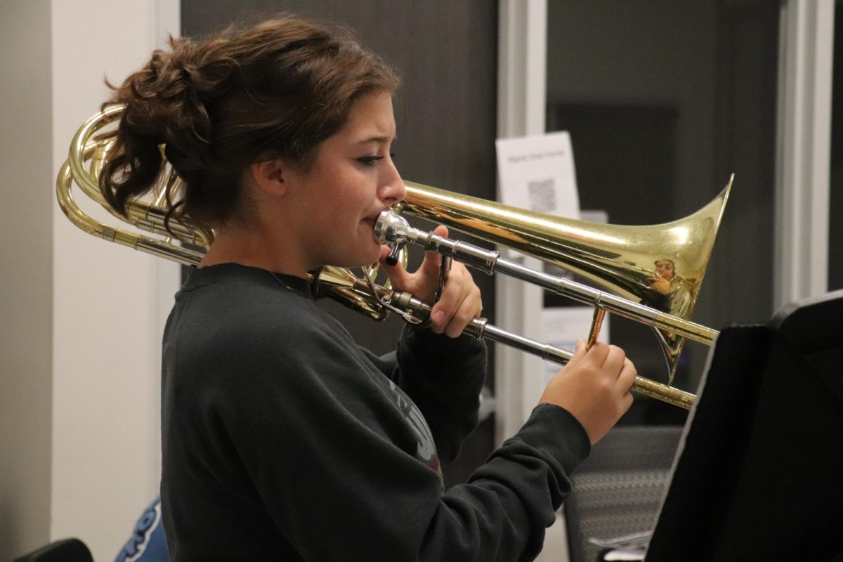 Junior Emmie Dodson plays through the music given to her by Assistant Director Hayden Drew.