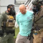 Police respond to a standoff at a home in Creston after a man climbs onto the roof